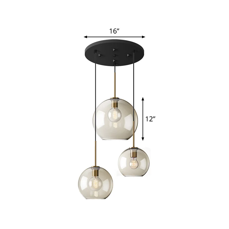 Eenvoudige hangverlichting met 3 lampen en amberkleurige glazen kap Zwarte ronde hanger met meerdere lampen Clearhalo