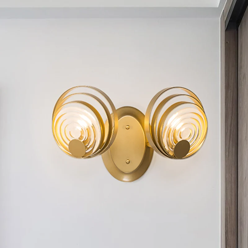 Gouden 1/2-lichts wandkandelaar licht minimalistisch metallic wervelend rond wandverlichtingsidee Clearhalo