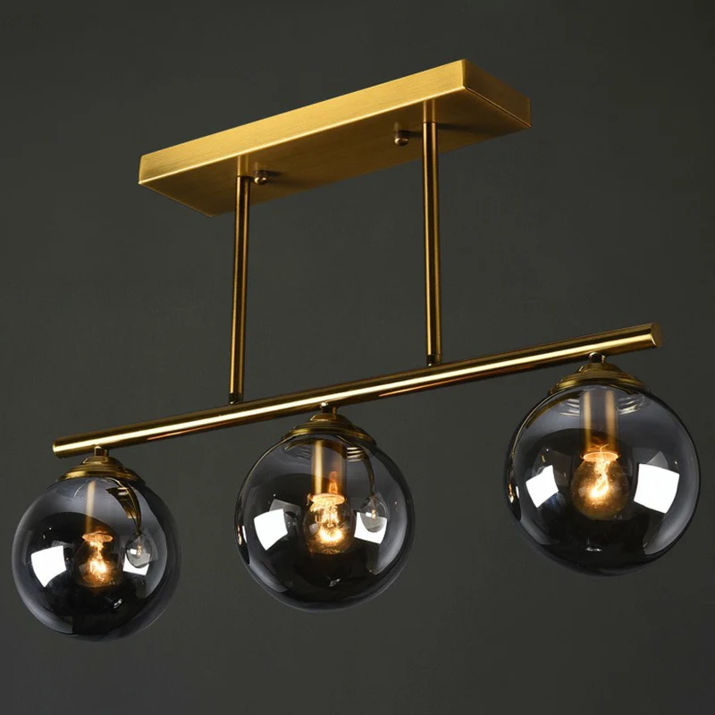 Messing lineaire eilandlamp, postmodern metalen plafondlamp met bolvormige glazen kap Clearhalo
